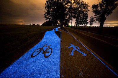 Glowing engine powering a glow-in-the-dark bicycle path at night